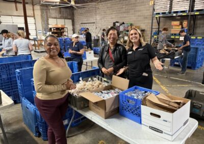 Groups of BCH team members organizing food and water at the food bank